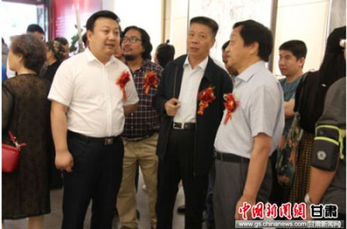 中共甘肃省委宣传部常务副部长高志凌（右二）同潘义奎（左一）、王骁勇（右一）参观画展。